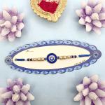 Elegant Blue Evil Eye & Pearl Rakhi with Gold Accents