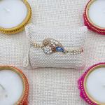 Elegant Rhinestone Peacock Rakhi - Golden Detail