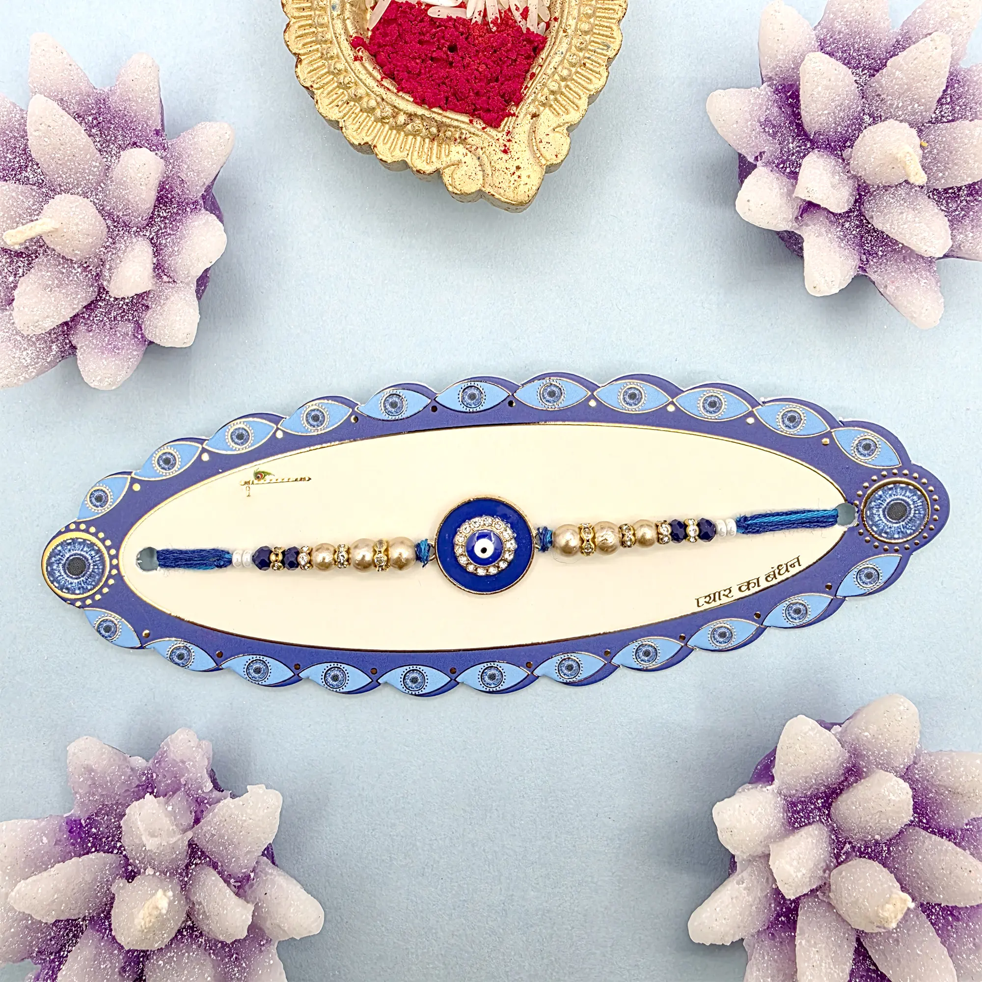 Elegant Blue Evil Eye & Pearl Rakhi with Gold Accents