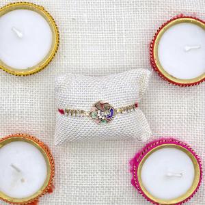 Elegant Enamel Peacock Rakhi with Diamond Embellishments