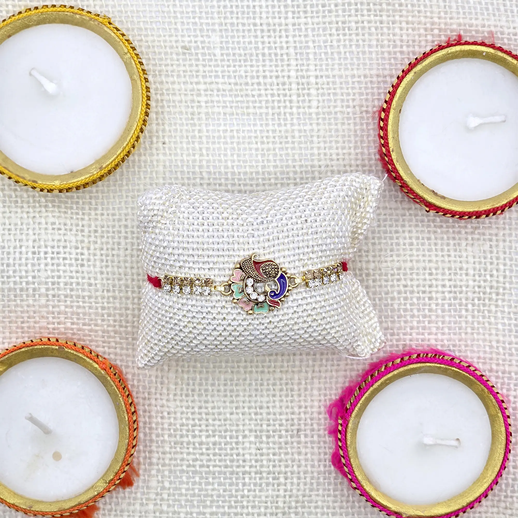 Elegant Enamel Peacock Rakhi with Diamond Embellishments