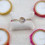 Elegant Enamel Peacock Rakhi with Diamond Embellishments