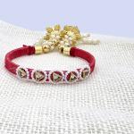 Traditional Red Thread Rakhi with Pearl and Gold Tassels
